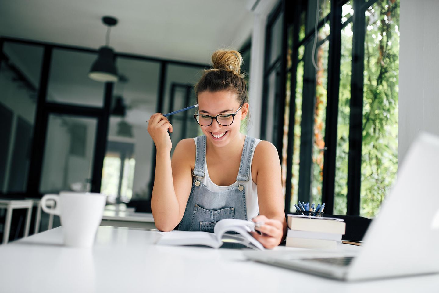 Young mother sits at the table and works