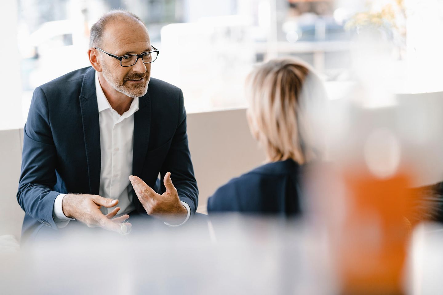 Man and woman sit across and talk