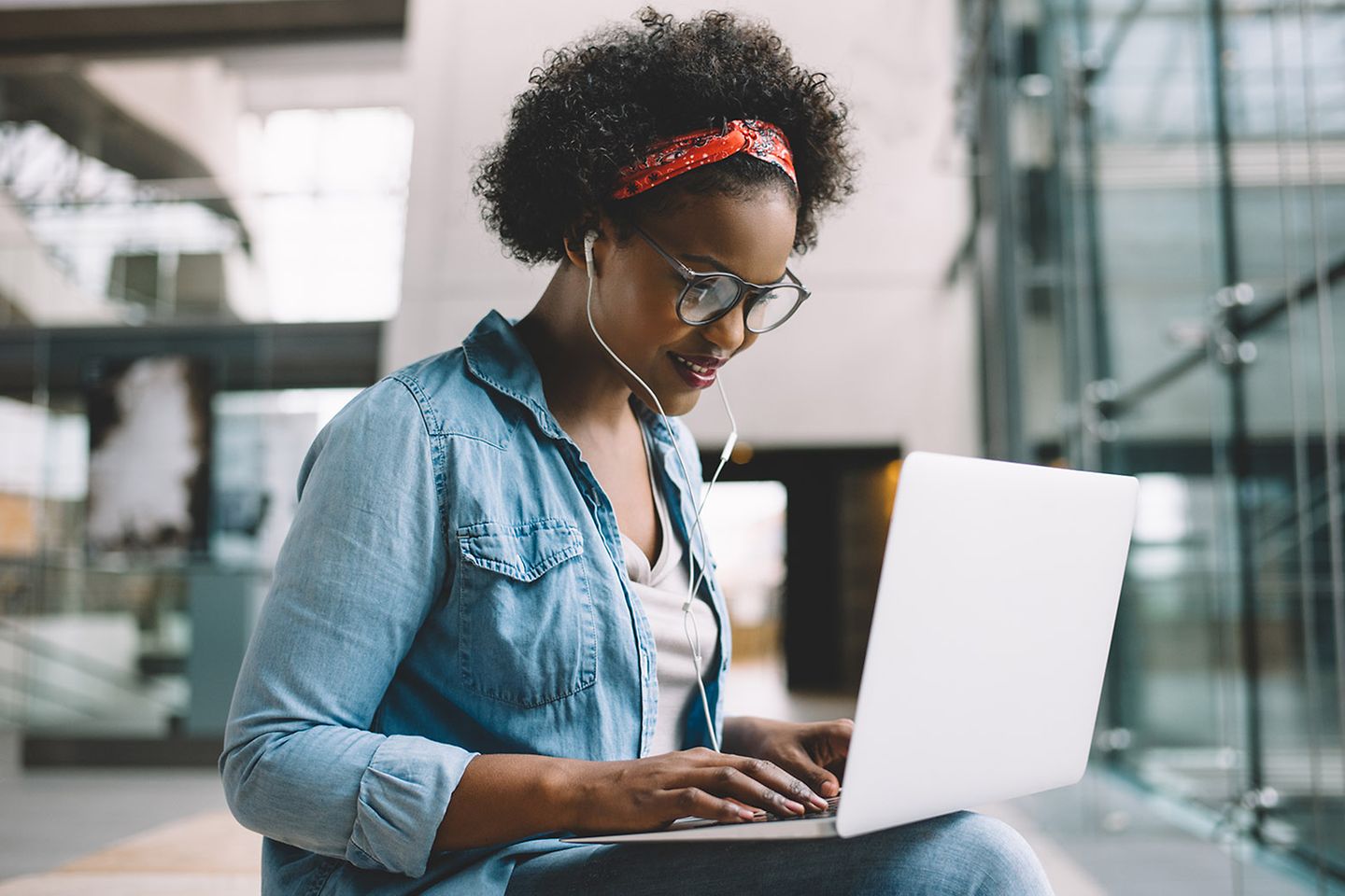 Female student is sitting at laptop and working