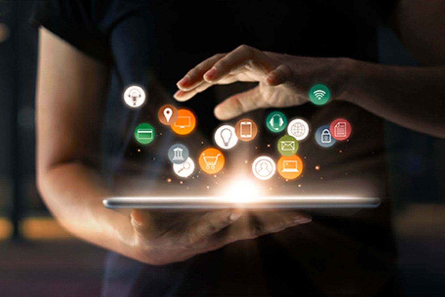 Woman serves a variety of round icons on a glowing tablet.