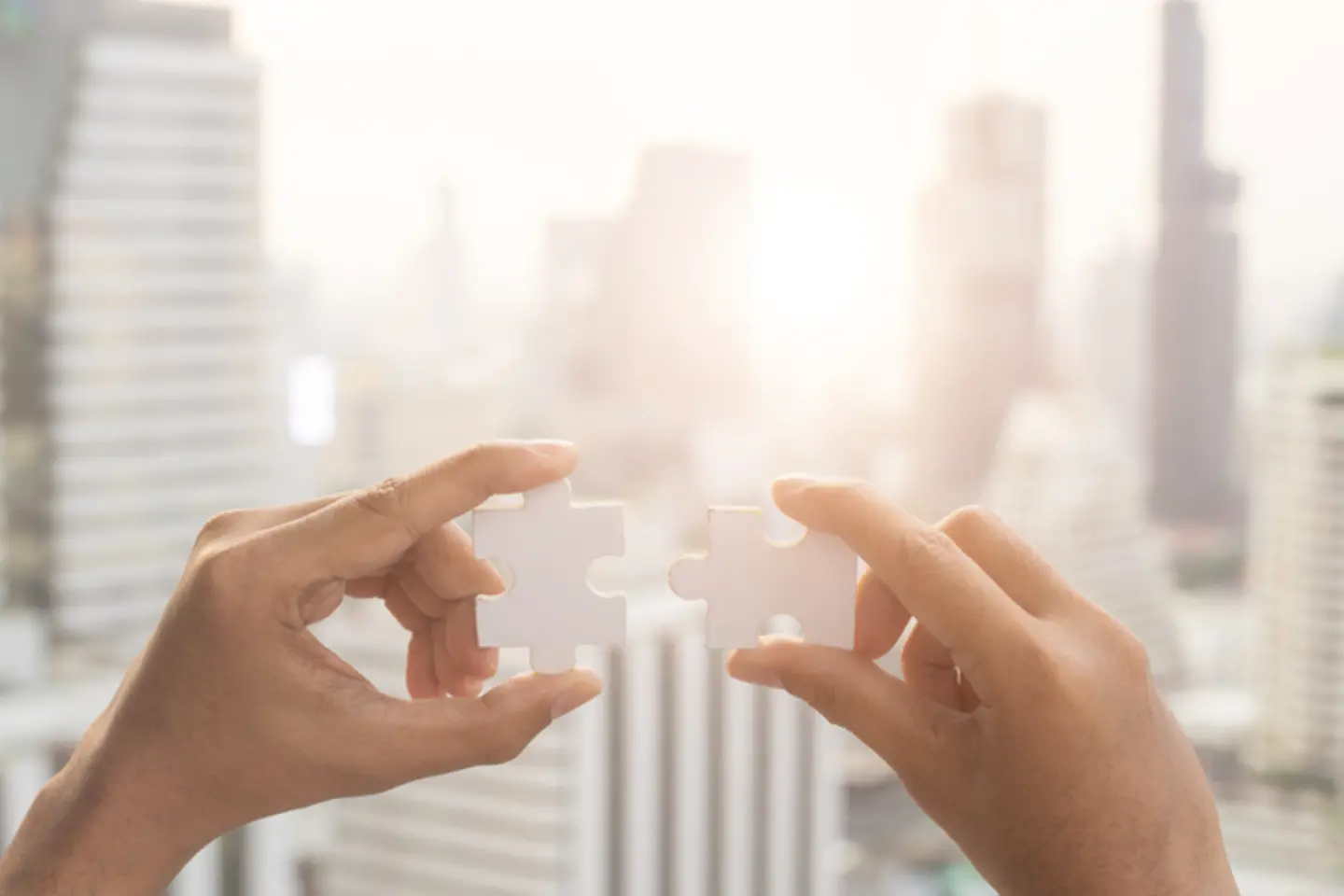 hands holding puzzle pieces