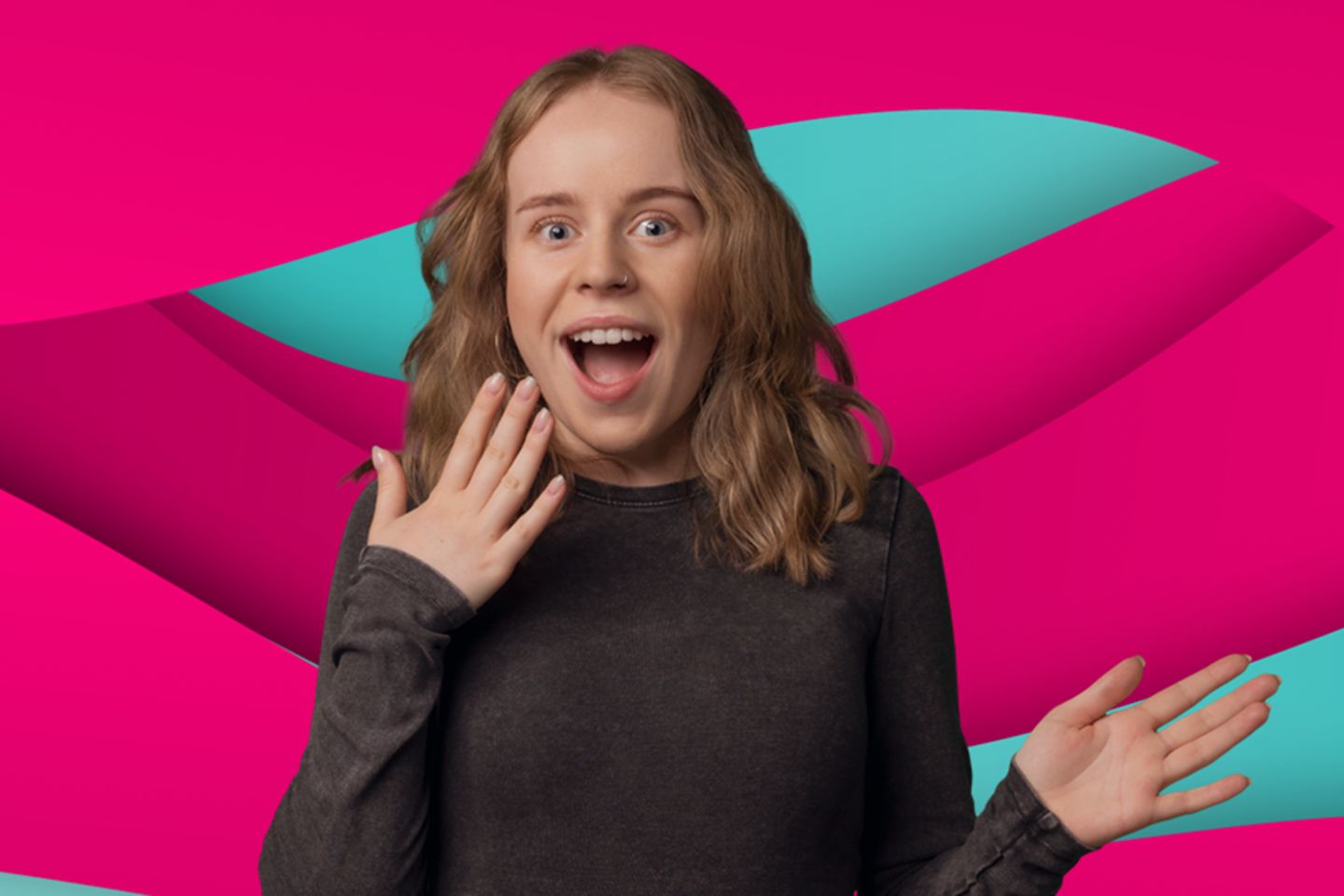 Young woman in a magenta blazer is standing against a wall